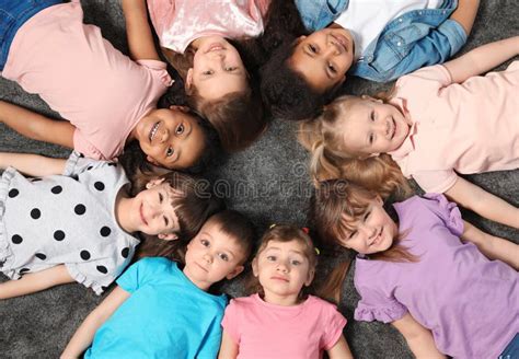 Adorable Little Children Lying On Floor Together Indoors Kindergarten