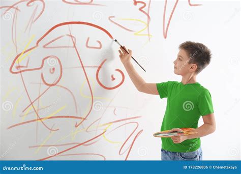 Little Child Drawing Scribbles On White Wall Stock Photo Image Of