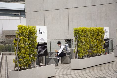 Japanese People And Foreign Travelers Relax And Smoke Cigarette At