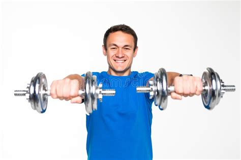 Handsome Muscular Man Uses His Dumbbell To Exercise Flexing Bicep