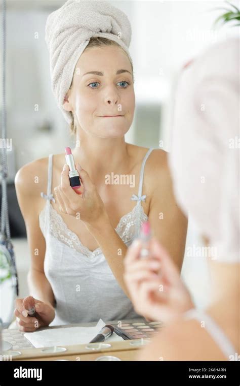 Beautiful Woman Rubbing Her Lips Together After Applying Lipstick Stock Photo Alamy