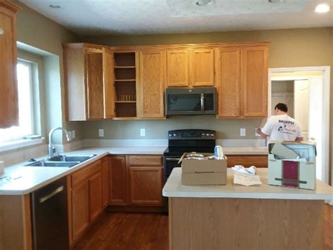 Full overlay, raised panel door and drawer front. Glossy White Paint on Honey Oak Kitchen Cabinets | Before ...