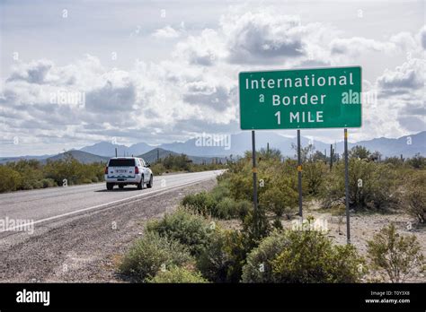 Vehicle Approaches International Border With Mexico And Usa Sign