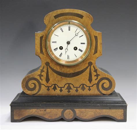 A Late 19th Century Burr Walnut And Ebonized Mantel Clock With Eight Day Movement Striking On A Bell
