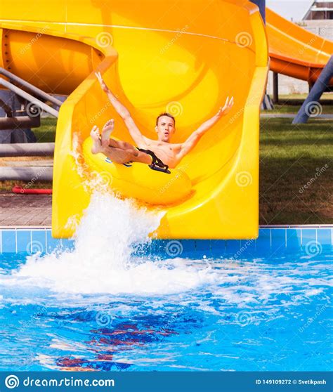 Funny Excited Man Enjoying Summer Vacation In Water Park Riding Yellow