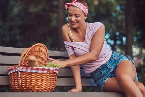 Happy Beautiful Redhead Female Wearing Casual Clothes Holds A Picnic