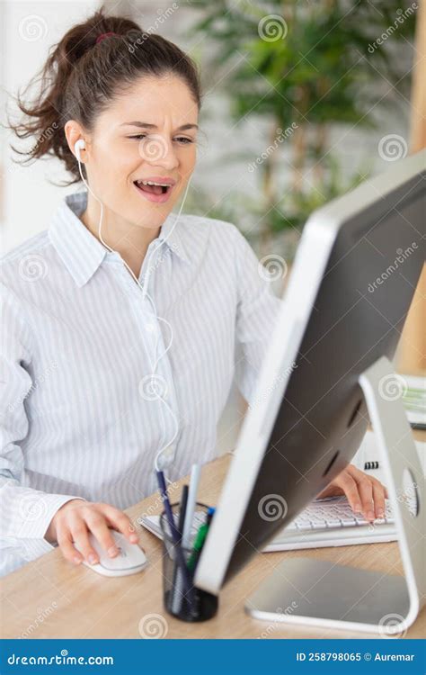 smiling woman sitting at desk in office stock image image of happy woman 258798065