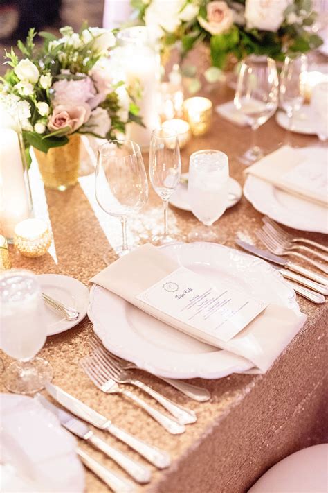 Table settings at this outdoor wedding in palm springs, california, kept to the pink color scheme with light and dark pink rose centerpieces from hope flower farm and gold trimmed dishware and gold silverware. Place Setting at Rose Gold Table Setting