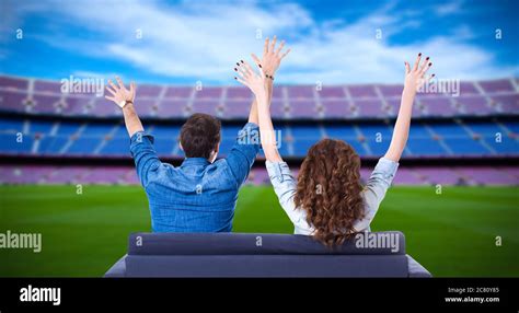 Young Couple Of Soccer Fans Supporting Their Team Or Celebrating Goal