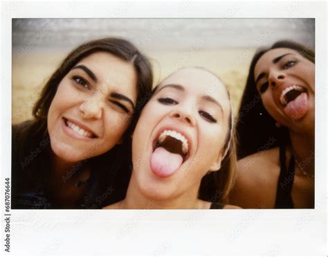 Instant Shot Of Three Funny Girls Sticking Out Tongues Three Young