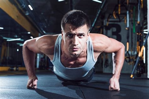 Portrait Of A Muscular Man Doing Push Ups In Gym Photo Free Download