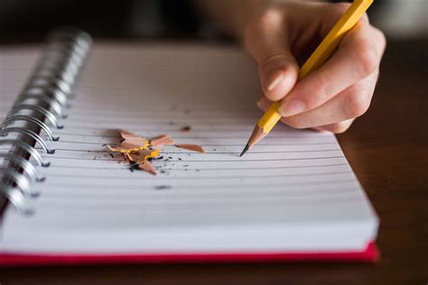 Writing Person Holding Pencil Writing On Notebook Notebook Image Free Photo