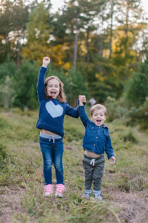Cute Brother And Sister Holding Hands And Laughing By Stocksy Contributor Jakob Lagerstedt