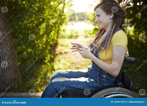Smiling Disabled Girl Having Fun With Her Smart Phone Stock Image