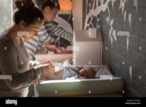 Mother Changing Baby Diaper Stock Photo Alamy
