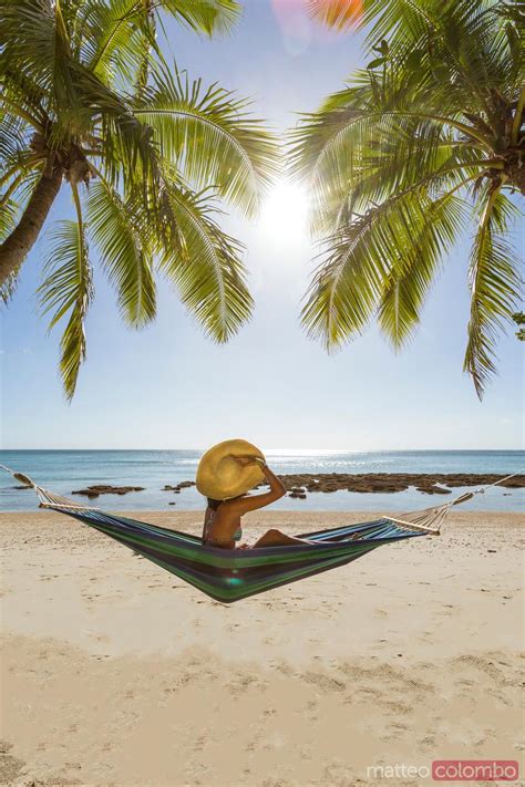 Woman Relaxing On Hammock Under Palm Tree On A Tropical Beach Fiji