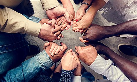 Group of diverse hands holding each other support together ...