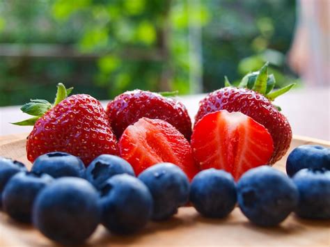Premium Photo Strawberries And Blueberries In Summer