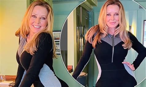 Carol Vorderman Shows Off Her Impressive Curves In A Skin Tight Catsuit As She Skips Through A Bar