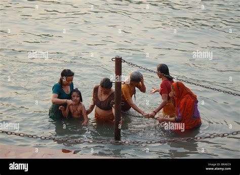 Women Bathing In Holy River Ganges In India During Kumbh Mela Stock