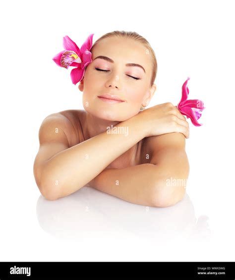 beautiful sleeping woman in spa salon pretty female face with pink orchid flower cute girl