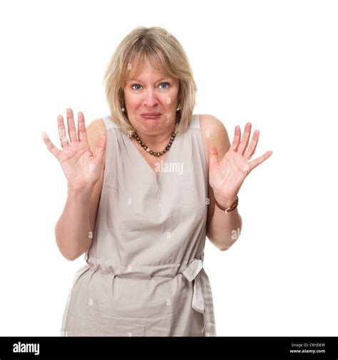 Attractive Mature Woman With Shocked Horrified Expression Holding Up