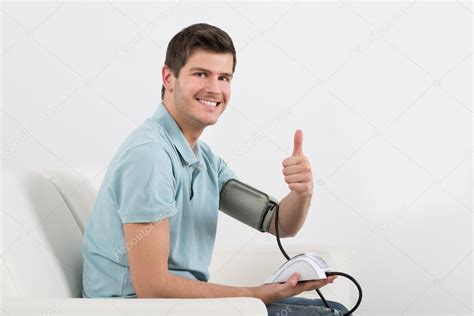 Happy Man Measuring Blood Pressure — Stock Photo © Andreypopov 104933132