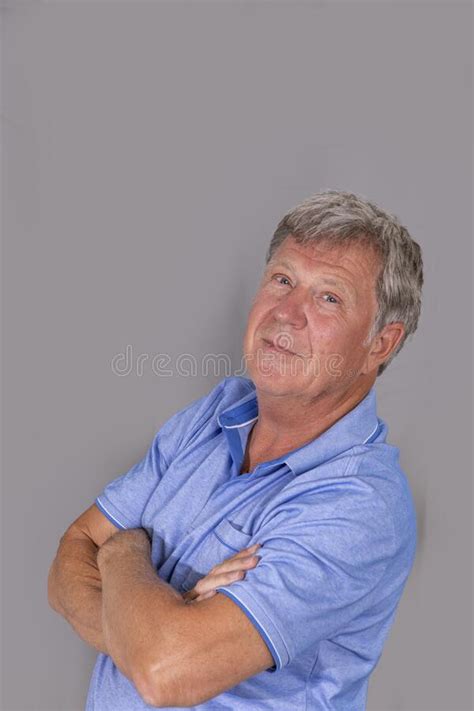 Portrait Of Sixty Year Old Attractive Senior Man In Blue Shirt Stock