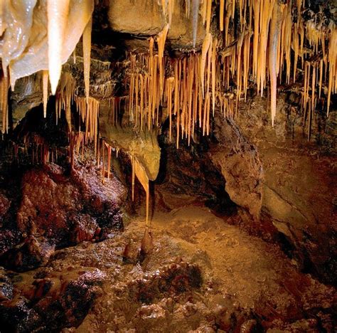 The Inside Of A Cave With Icicles Hanging From It