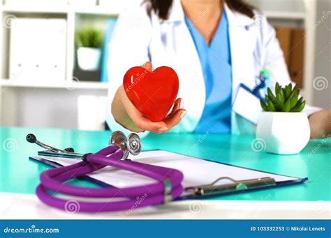 Woman Doctor With A Stethoscope Holds A Heart Stock Image Image Of