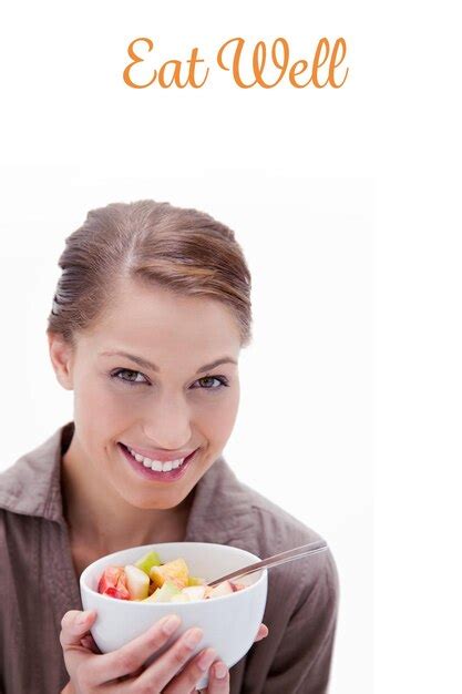 Premium Photo The Word Eat Well Against Smiling Woman With Bowl Of