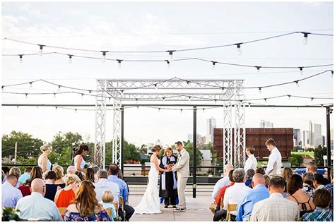 A Couple Getting Married Under An Outdoor Ceremony