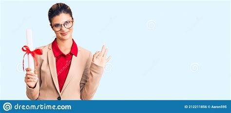 Young Beautiful Woman Wearing Glasses Holding Graduate Degree Diploma Doing Ok Sign With Fingers