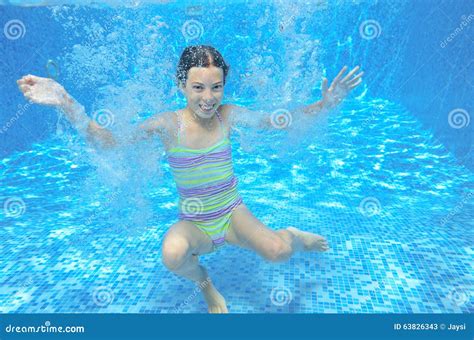 Girl Jumps And Swims In Pool Underwater Happy Active Child Has Fun