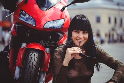 Happy Woman Biker Sitting Near Motorcycle And Happy Close Up Brunette