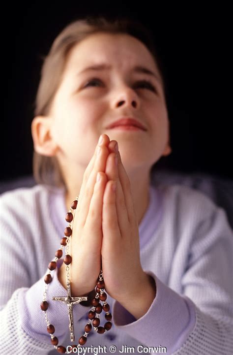 Young Girl In Prayer Holding A Rosary In Her Hands Jim Corwin