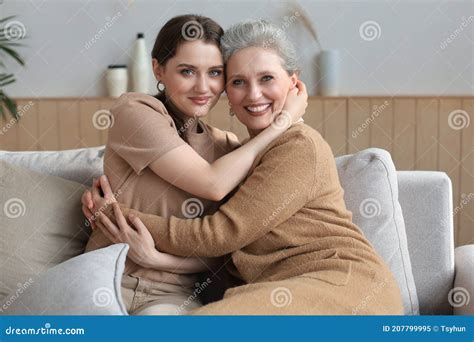 Portrait Of Old Mother And Mature Daughter Hugging At Home Happy Senior Mom And Adult Daughter