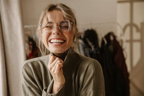 Close Up Young Caucasian Woman Laughing Hard While Screwing Up Eyes