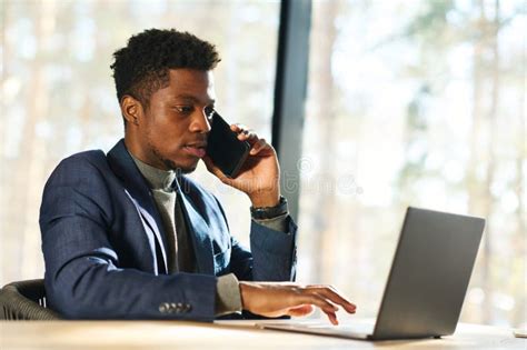 Young Confident Male Broker Or Agent Talking To Client On Smartphone