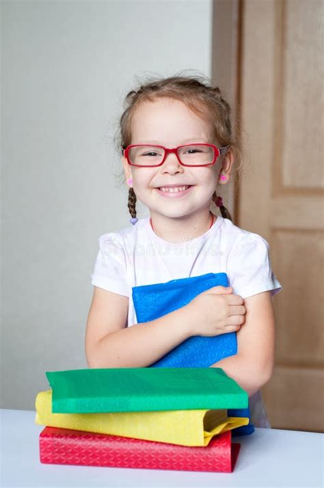 Portrait Of Sweet Little Girl Wearing Glasses Reading Book Sit Stock