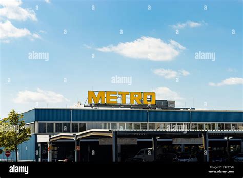 Metro Logo Sign On Top Of The Blue Wholesale Building The German