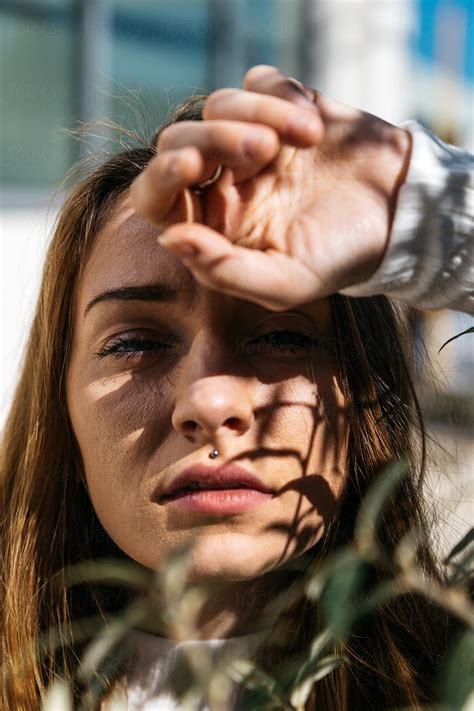 Portrait Of Young Adult Female Outdoors With Shadows And Face Obscure