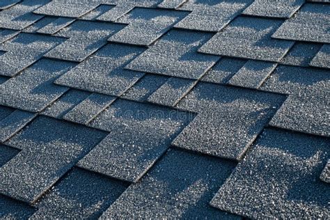 Close Up View On Asphalt Roofing Shingles Covered With Frost Stock