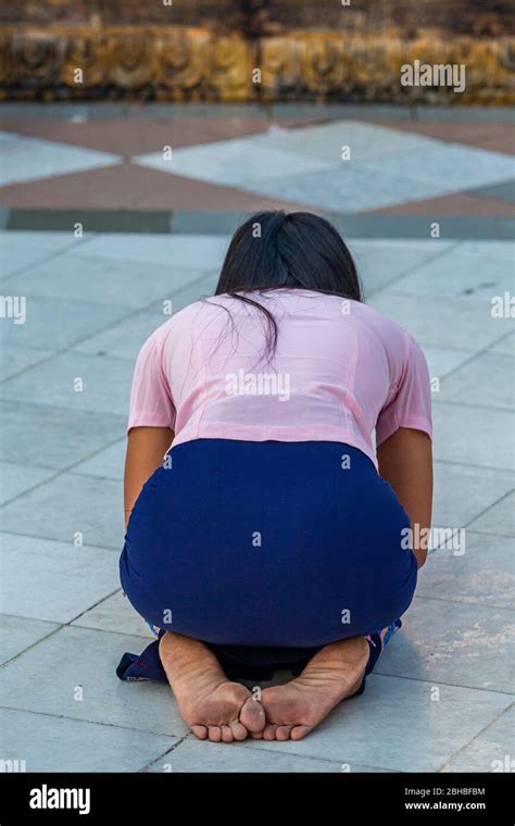 Young Burmese Woman Praying In Front Of Shwedagon Pagoda In Yangon