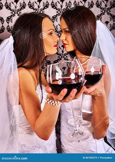 Lesbian Couples In Wedding Bridal Dress Kissing And Drinking Red Wine Stock Image Image Of