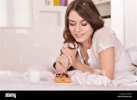 Beautiful Woman In Bed With Cake Stock Photo Alamy