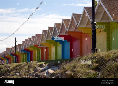 Row Of Brightly Painted Beach Huts Along The Seafront North Bay