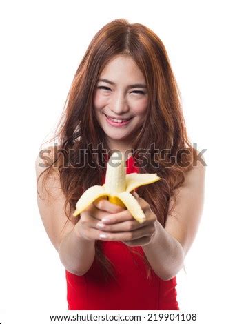 Beautiful Asian Woman Eating Banana On White Background Stock Photo