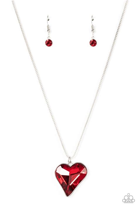 P2wh Rdxx 311xx A Shimmering Red Heart Shaped Gem Is Pressed Into A
