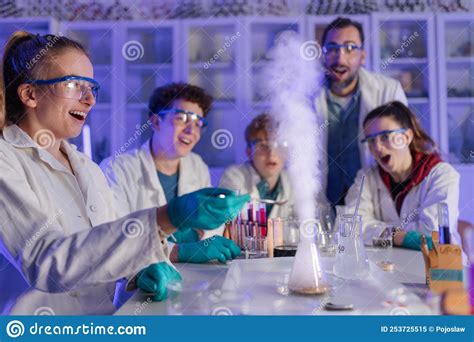 Excited Science Students With Teacher Doing Chemical Experiment In The